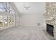 Bright living room with fireplace and floor to ceiling windows and doors offering a great view of the surrounding property at 8116 Windsor Ridge Dr, Raleigh, NC 27615