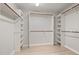 Spacious walk-in closet with custom shelving and wooden racks for optimal storage at 8116 Windsor Ridge Dr, Raleigh, NC 27615