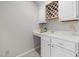 Close-up on the wet bar with a white marble countertop, sink, wine rack, and lots of counter space at 8116 Windsor Ridge Dr, Raleigh, NC 27615