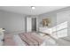 Comfortable bedroom featuring neutral walls, closet and decorative chest of drawers at 8729 Maxine St # 38, Willow Springs, NC 27592