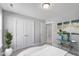 Bright bedroom with neutral walls, closet and glass table with blue vases at 8729 Maxine St # 38, Willow Springs, NC 27592