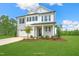 Beautiful two-story home featuring a well-manicured lawn and classic architecture with a gray brick facade at 8729 Maxine St # 38, Willow Springs, NC 27592
