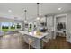Modern kitchen featuring an island with barstool seating, pendant lighting, and stainless steel appliances at 8729 Maxine St # 38, Willow Springs, NC 27592