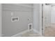 Utility room featuring tile flooring, washer/dryer hookups, and overhead wire shelving at 8729 Maxine St # 38, Willow Springs, NC 27592