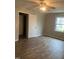This bedroom features wood-look flooring, neutral paint, a closet, and a window with a view at 912 Pamela Ln, Rocky Mount, NC 27803