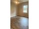 This bedroom features wood-look flooring, a ceiling fan, and a window with a view at 912 Pamela Ln, Rocky Mount, NC 27803