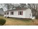 A side exterior showing brick foundation, white siding, and red shutters at 912 Pamela Ln, Rocky Mount, NC 27803