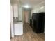 A clean kitchen design with white cabinets, black appliances and modern flooring at 912 Pamela Ln, Rocky Mount, NC 27803