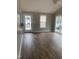 Bright living room with hardwood floors, a fan, and a glass patio door at 912 Pamela Ln, Rocky Mount, NC 27803