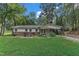 Inviting single-story home featuring a well-manicured lawn, brick detailing, and a pleasant front garden at 913 Ranch Farm Rd, Raleigh, NC 27603
