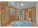 Unique living room with brick flooring, wood paneling, and a light-filled entry door at 913 Ranch Farm Rd, Raleigh, NC 27603