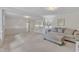 Bright, neutral living room featuring fresh paint, plush carpeting and a sofa with decorative pillows at 913 Ranch Farm Rd, Raleigh, NC 27603