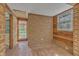 Unique sunroom with brick flooring and walls, offering abundant natural light and charm at 913 Ranch Farm Rd, Raleigh, NC 27603