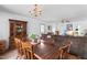 Open dining room with hardwood floors, chandelier, and seamless flow into the living area at 918 Circle Dr, Angier, NC 27501
