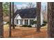 Charming single-story home with white siding, black shutters, and well-manicured landscaping at 918 Circle Dr, Angier, NC 27501