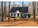 Charming single Gathering home with a well-manicured lawn, black shutters, and a cozy front porch at 918 Circle Dr, Angier, NC 27501