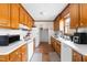 Functional kitchen with wooden cabinets, white appliances, and ample counter space at 918 Circle Dr, Angier, NC 27501