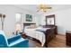 Bright primary bedroom featuring a queen-size bed, natural lighting, and hardwood floors at 918 Circle Dr, Angier, NC 27501