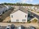 Birds-eye view of townhomes showcasing rear exteriors, parking, and tidy landscaping at 1003 Mirbeck Ln, Durham, NC 27713