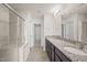 Bright bathroom with dual sink granite countertop vanity and glass enclosed shower at 1003 Mirbeck Ln, Durham, NC 27713