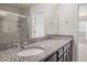 Bathroom with dual sink granite countertop vanity, large mirror and glass enclosed shower at 1003 Mirbeck Ln, Durham, NC 27713