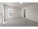 Bright bedroom featuring neutral walls, carpet, window with blinds and a closet at 1003 Mirbeck Ln, Durham, NC 27713