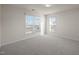Bright bedroom with neutral carpet and multiple windows providing ample natural light at 1003 Mirbeck Ln, Durham, NC 27713