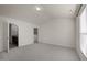 A spacious bedroom with neutral walls, carpet, and connected bathroom at 1003 Mirbeck Ln, Durham, NC 27713