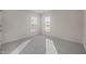 Well lit bedroom features neutral walls, carpet, and two windows with blinds at 1003 Mirbeck Ln, Durham, NC 27713