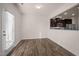 Bright dining area featuring wood floors, a door to the outside, and a pass-through to the kitchen at 1003 Mirbeck Ln, Durham, NC 27713