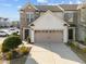 Charming townhome showcasing brick and siding with a two-car garage and well-maintained landscaping at 1003 Mirbeck Ln, Durham, NC 27713