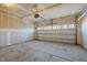 Spacious two-car garage with unfinished walls, concrete flooring, and a partially open garage door at 1003 Mirbeck Ln, Durham, NC 27713
