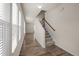 Bright hallway with wood floors, staircase, and natural light from large windows at 1003 Mirbeck Ln, Durham, NC 27713