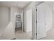 Hallway with a laundry room featuring a washing machine and dryer and storage shelves at 1003 Mirbeck Ln, Durham, NC 27713