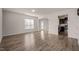 Open living room showcasing wood floors, a view into the kitchen, and ample natural light at 1003 Mirbeck Ln, Durham, NC 27713