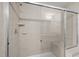 Shower with clear glass door and tile surround featuring built in bench and shelving at 1003 Mirbeck Ln, Durham, NC 27713