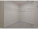 Walk-in closet with gray carpet and installed metal shelving at 1003 Mirbeck Ln, Durham, NC 27713
