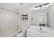 This bright bathroom features a white vanity, a large mirror, and a shower-tub combo with tile surround at 101 Palmwood Ct, Cary, NC 27519