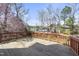 The outdoor deck has a wood railing and overlooks the backyard with lush trees at 101 Palmwood Ct, Cary, NC 27519