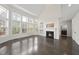 Open living room with fireplace, dark wood floors, and lots of natural light at 101 Palmwood Ct, Cary, NC 27519