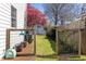 Backyard with flower tree, a tool shed, and an enclosed gardening area at 1010 Rosehill Ave, Durham, NC 27705