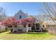 Landscaped backyard features mature trees and shrubs, lush green grass and a view of the home's screened porch at 1010 Rosehill Ave, Durham, NC 27705