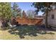 Private backyard with a wooden privacy fence, established trees and grass, along with outdoor seating at 1010 Rosehill Ave, Durham, NC 27705