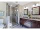 Bright bathroom featuring double sinks, granite counters, and a glass shower at 1010 Rosehill Ave, Durham, NC 27705