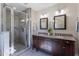 Bathroom boasts double sinks, granite counters, a glass shower and decorative floral accent at 1010 Rosehill Ave, Durham, NC 27705