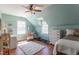Bright bedroom with sloped ceilings, a ceiling fan, hardwood floors, and plenty of natural light at 1010 Rosehill Ave, Durham, NC 27705