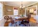 Formal dining room showcasing wainscoting, hardwood floors, and an elegant chandelier at 1010 Rosehill Ave, Durham, NC 27705