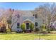 Charming two-story home with a brick walkway and flowering trees in a well-maintained front yard at 1010 Rosehill Ave, Durham, NC 27705