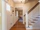 Inviting foyer with hardwood floors and staircase, offering a glimpse into the dining room beyond at 1010 Rosehill Ave, Durham, NC 27705