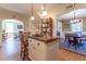 Bright kitchen boasts an island with seating and pendant lighting, with access to a dining area and living room at 1010 Rosehill Ave, Durham, NC 27705